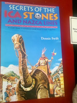 Cover of the book, 'Secrets of the Ica Stones and Nazca Lines' complete with a picture of an ancient person riding a dinosaur.